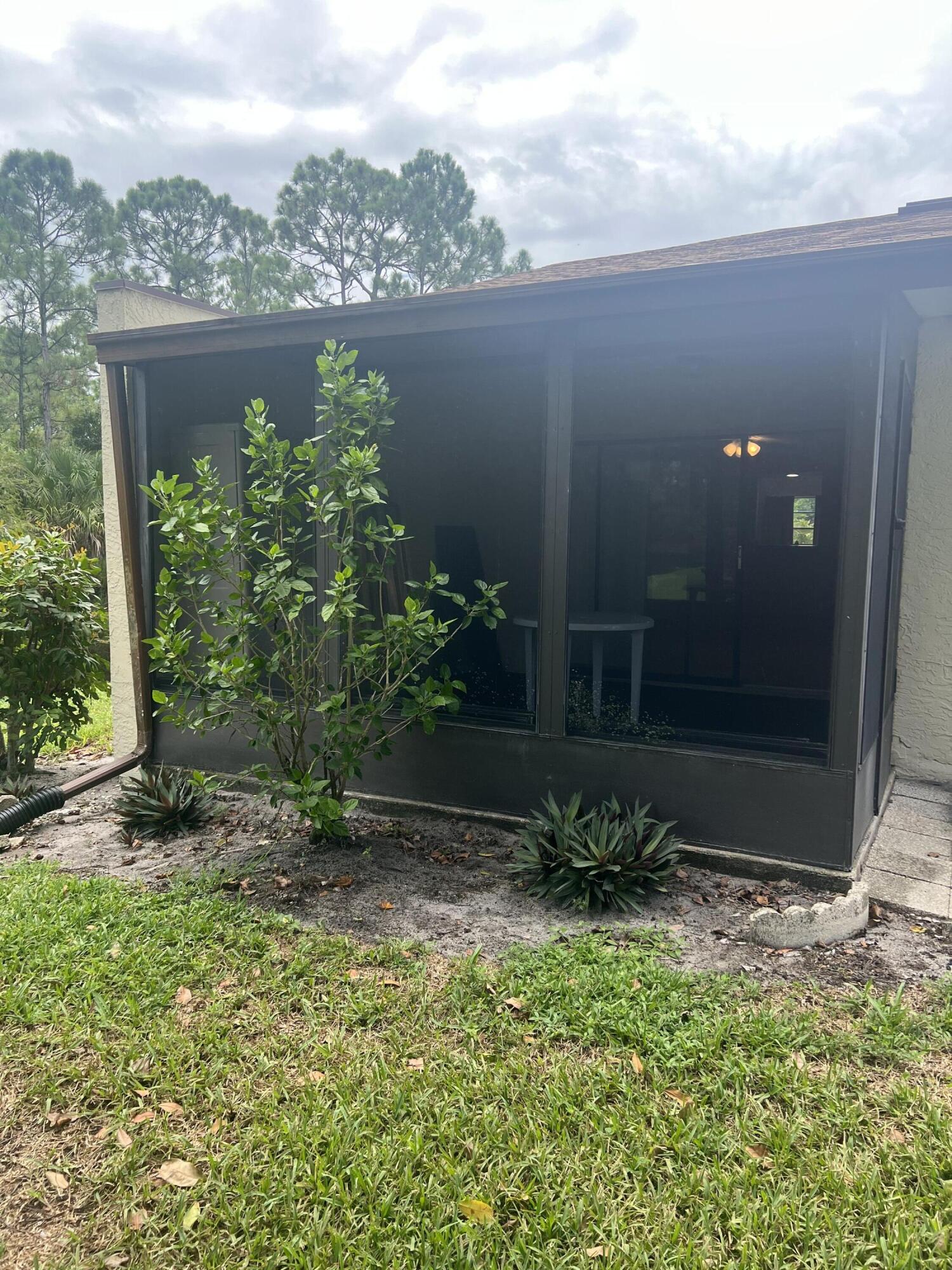 6032 Indrio Road, Unit 8 Fort Pierce, FL 34951 - Photo 18 of 26 Screened porch exterior