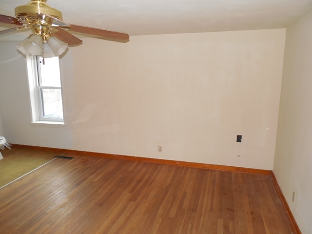 5925 Island Road Harvard, IL 60033 - Photo 17 of 22 a view of a room with wooden floor and chandelier fan