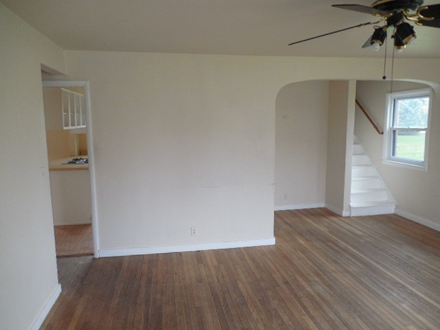 5925 Island Road Harvard, IL 60033 - Photo 6 of 22 an empty room with wooden floor and cabinet