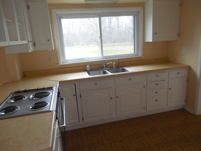 5925 Island Road Harvard, IL 60033 - Photo 10 of 22 a kitchen with sink a window and cabinets