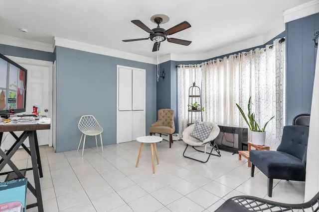 a living room with furniture and floor to ceiling window