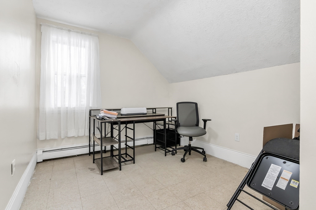 70 Butler Street Lawrence, MA 01841 - Photo 16 of 19 a view of a workspace with furniture and a window
