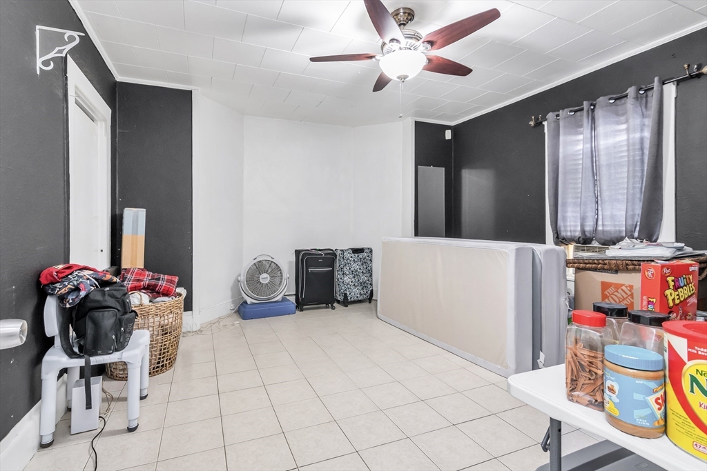 70 Butler Street Lawrence, MA 01841 - Photo 17 of 19 a bedroom with furniture and a fan