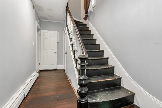 a view of entryway and hall with wooden floor