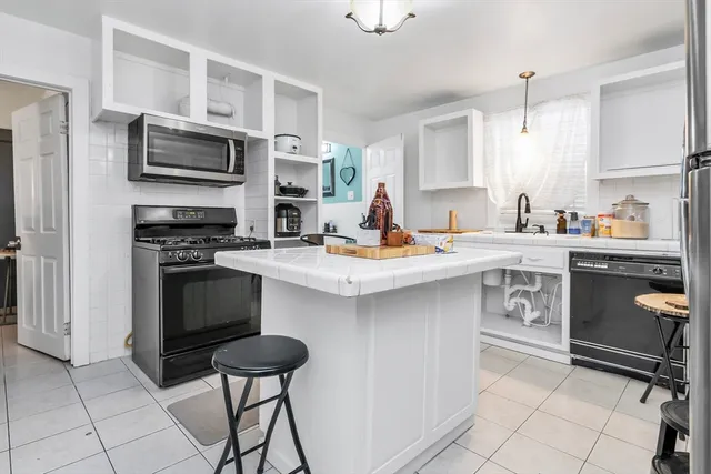 a kitchen with a sink cabinets and appliances