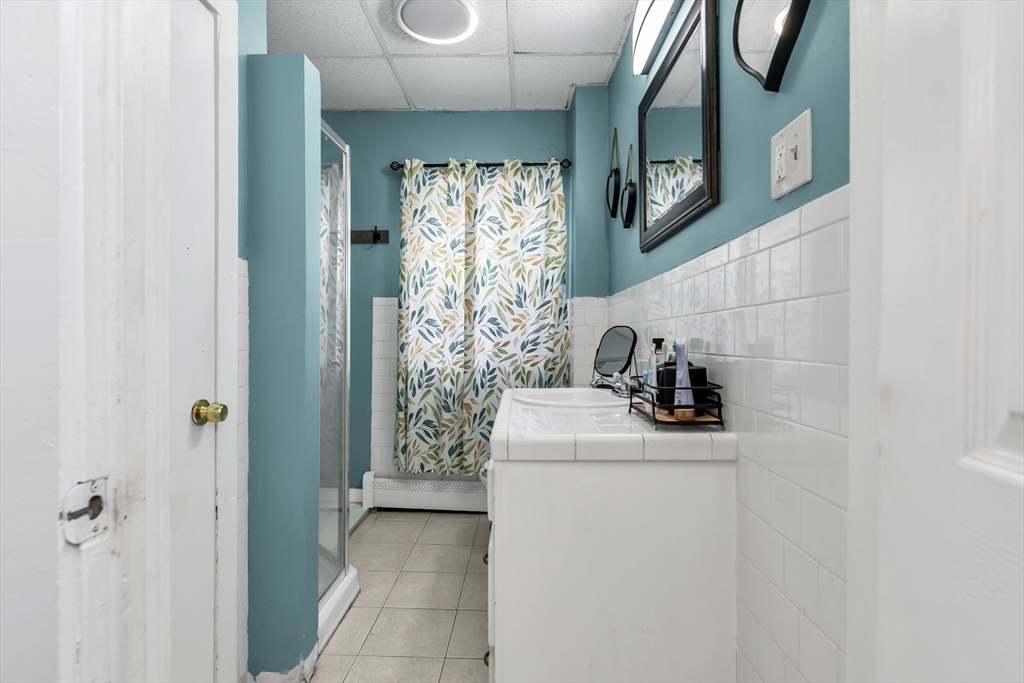 70 Butler Street Lawrence, MA 01841 - Photo 6 of 19 a bathroom with a sink and a mirror