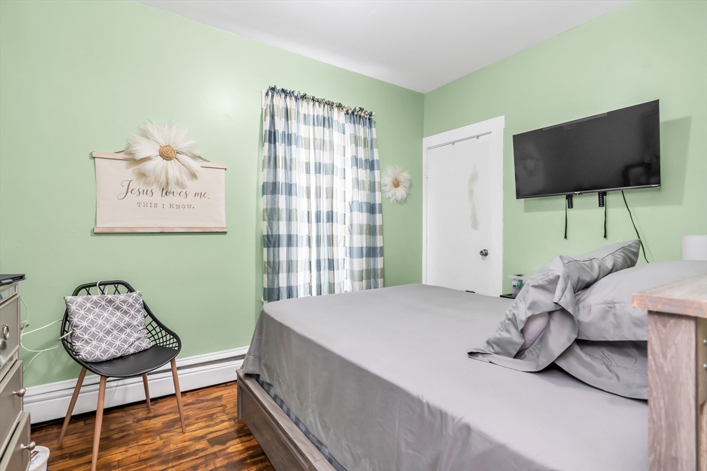 70 Butler Street Lawrence, MA 01841 - Photo 9 of 19 a bedroom with a bed and chair