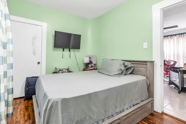 a bedroom with a bed and flat screen tv