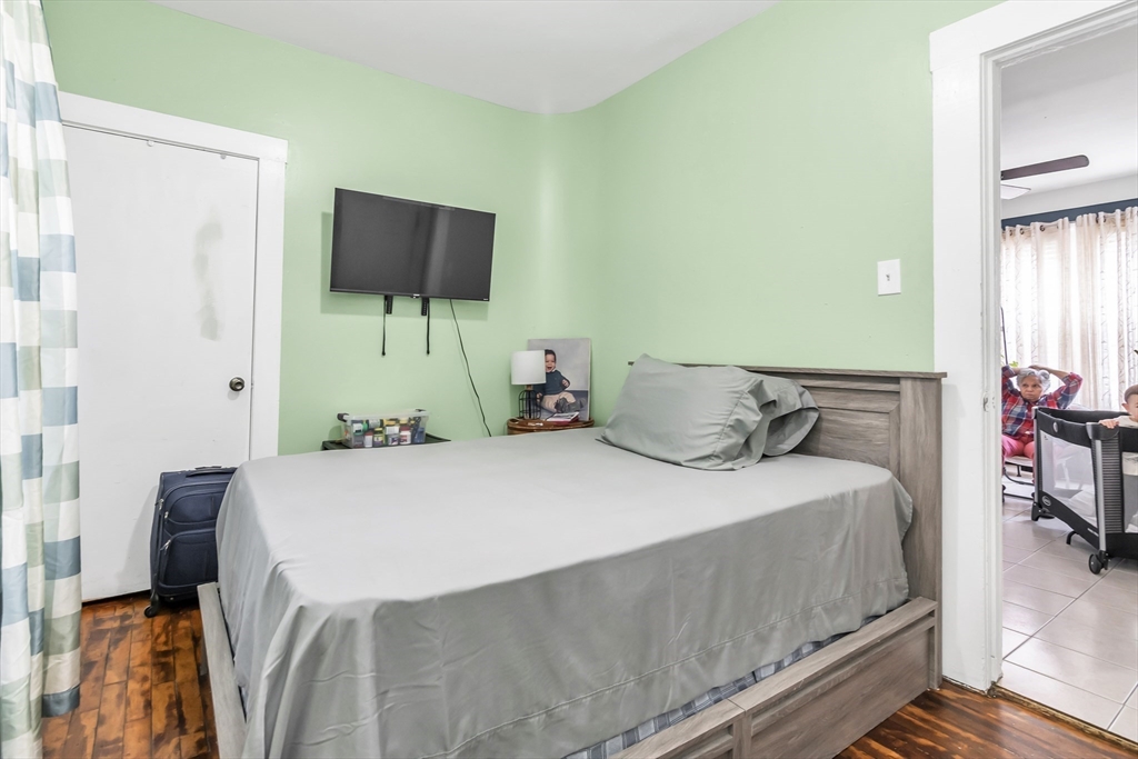70 Butler Street Lawrence, MA 01841 - Photo 10 of 19 a bedroom with a bed and flat screen tv