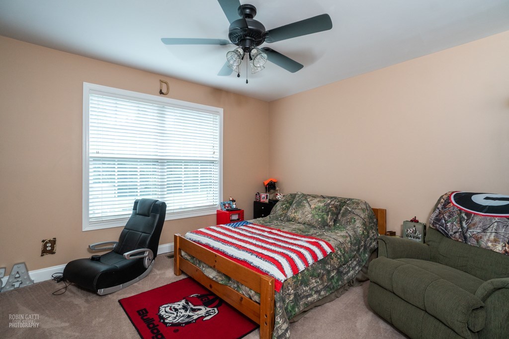 121 Gordon Road Gray, GA 31032 - Photo 22 of 32 a bedroom with a bed and a couch