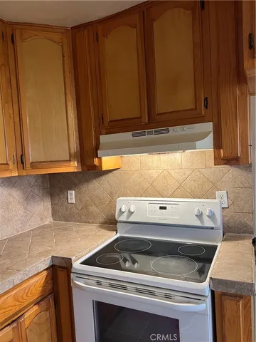 a stove top oven sitting inside of a kitchen