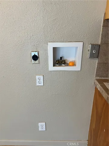 a view of an empty room with a painting on the wall