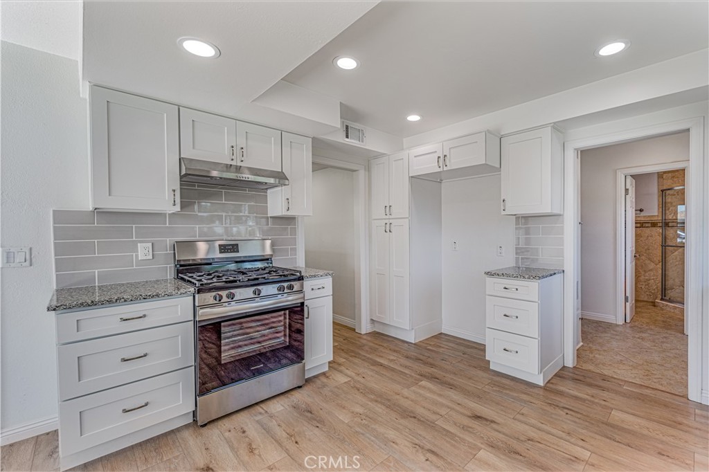 1480 East Colver Place Covina, CA 91724 - Photo 16 of 31 a kitchen with stainless steel appliances a stove and a refrigerator