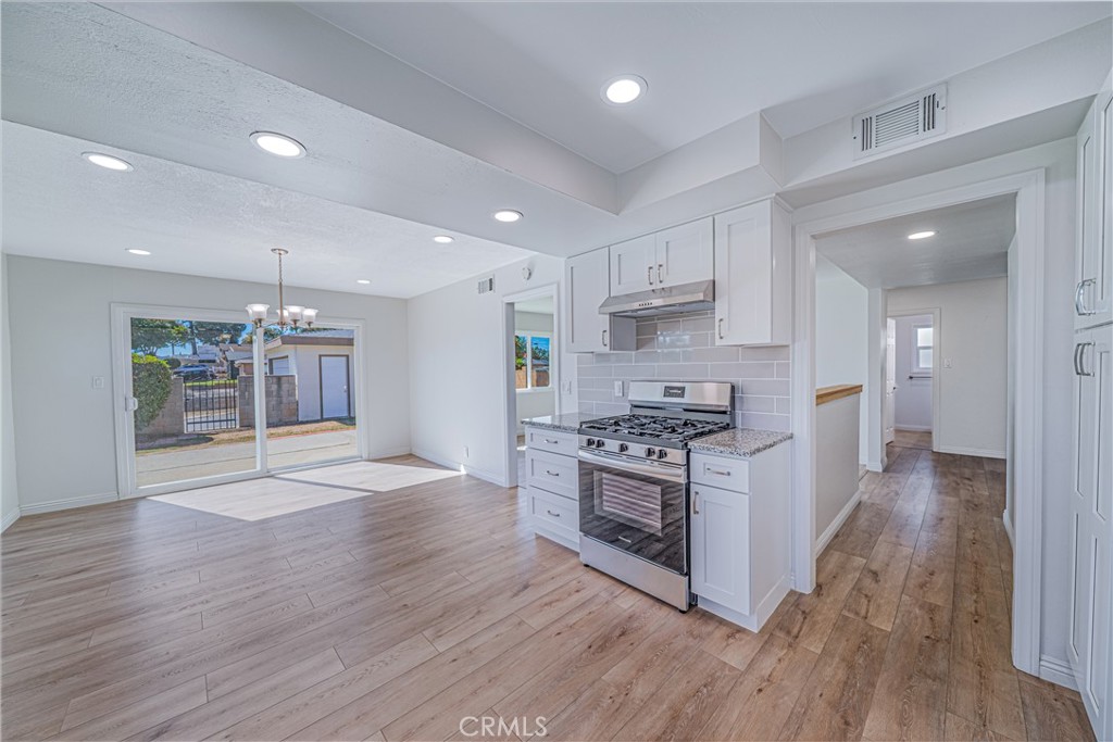 1480 East Colver Place Covina, CA 91724 - Photo 21 of 31 a large kitchen with cabinets wooden floor and stainless steel appliances
