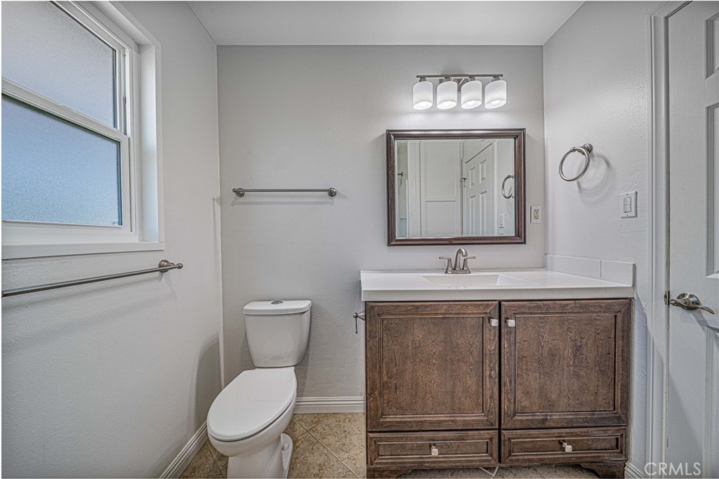 1480 East Colver Place Covina, CA 91724 - Photo 27 of 31 a bathroom with a toilet a sink and mirror