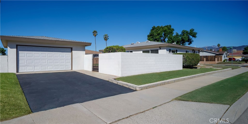 1480 East Colver Place Covina, CA 91724 - Photo 4 of 31 a front view of a house with a yard and garage