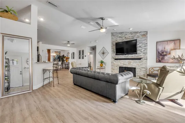 a living room with furniture a fireplace and a flat screen tv