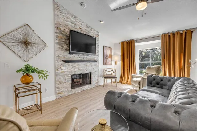 a living room with furniture fireplace and flat screen tv