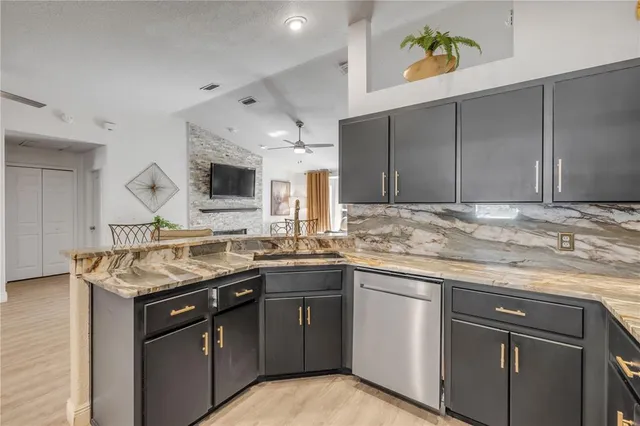 a kitchen that has a sink and a stove in it