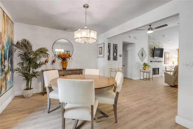 a view of a dining room with furniture wooden floor and chandelier