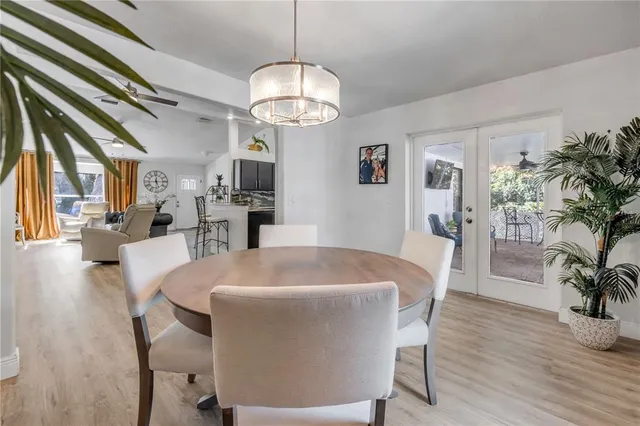 a view of a dining room with furniture wooden floor and chandelier