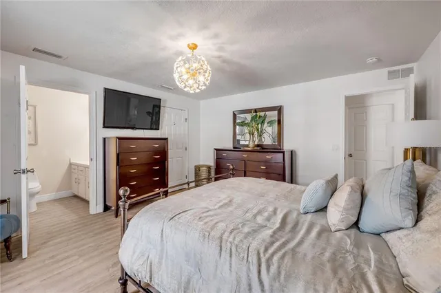 a bedroom with a bed and a tv on table