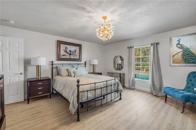 a spacious bedroom with a bed and a table in it