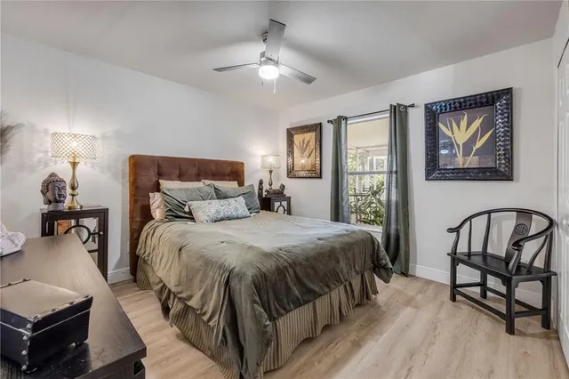 a bedroom with a bed a mirror and a dresser