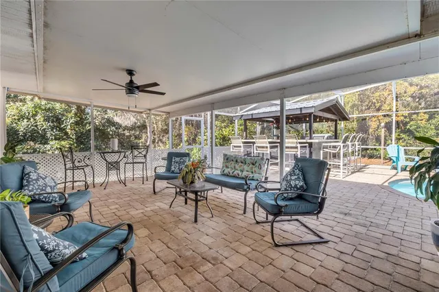a living room with furniture and a floor to ceiling window