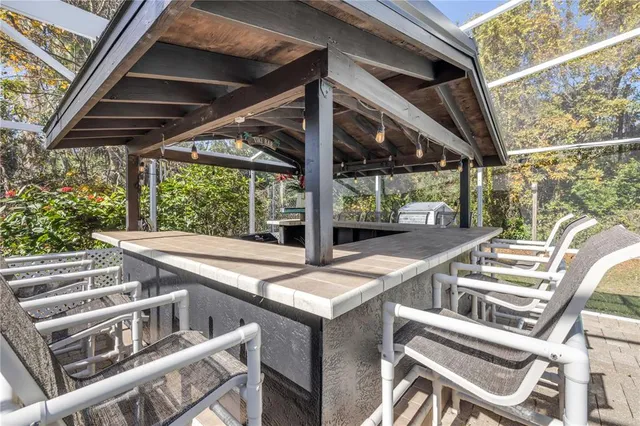 a view of a patio with table and chairs and wooden floor