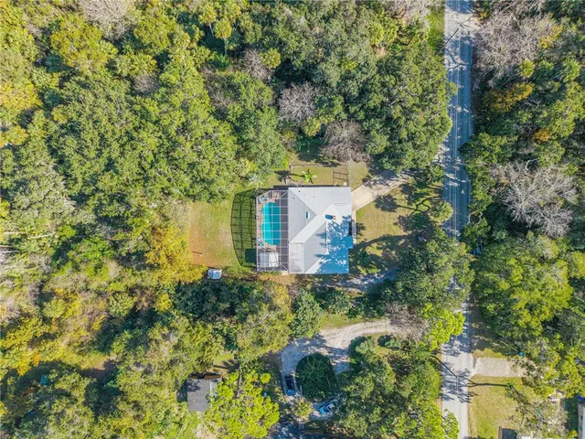 an aerial view of a house with a yard
