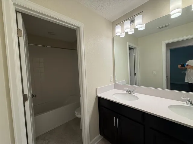 a bathroom with a sink double vanity and a mirror