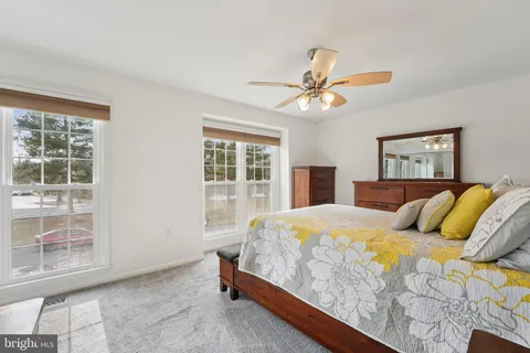 a bedroom with a large bed and a chandelier