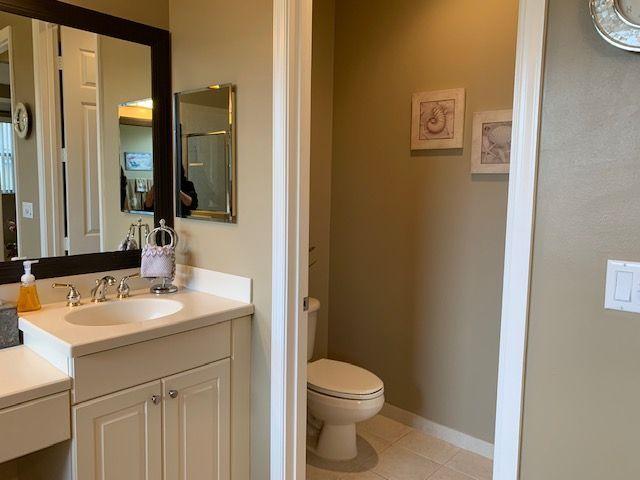 271 Southwest Walking Path Stuart, FL 34997 - Photo 17 of 35 a bathroom with a sink vanity mirror and toilet