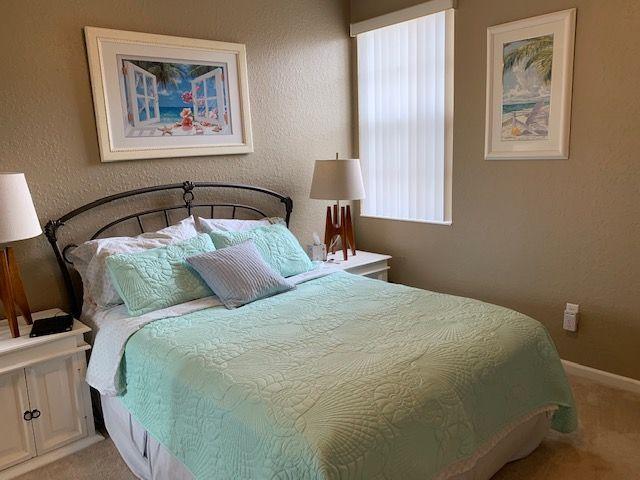 271 Southwest Walking Path Stuart, FL 34997 - Photo 23 of 35 a bedroom with a bed and a painting on the wall