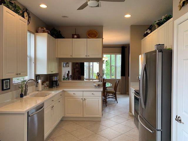 271 Southwest Walking Path Stuart, FL 34997 - Photo 4 of 35 a kitchen with a sink refrigerator and cabinets
