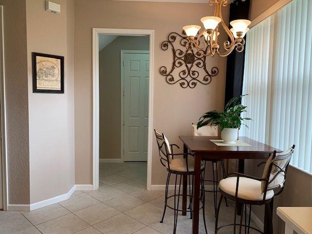 271 Southwest Walking Path Stuart, FL 34997 - Photo 6 of 35 a view of a dining room with furniture and chandelier