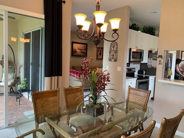271 Southwest Walking Path Stuart, FL 34997 - Photo 9 of 35 a view of a dining room with furniture and chandelier