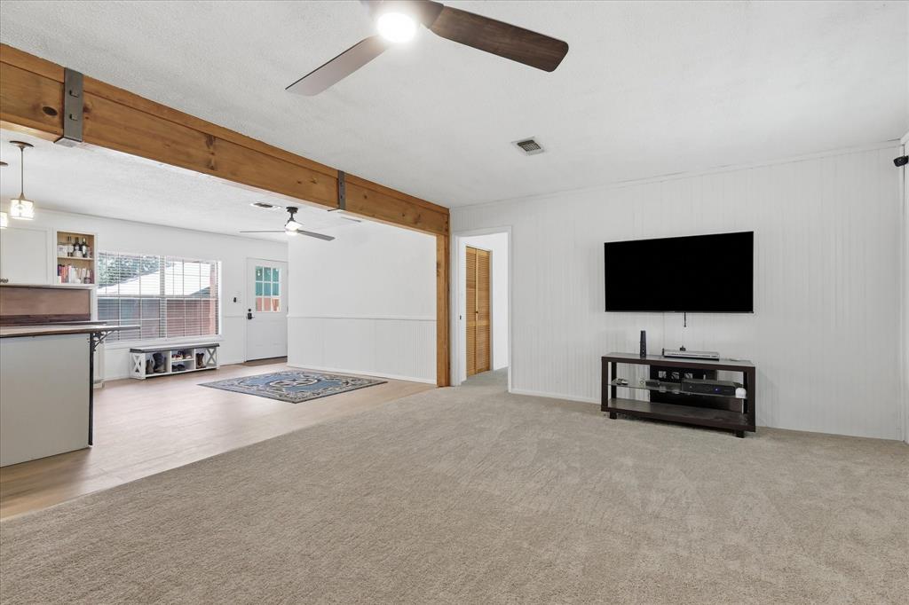 237 Brenda Lane Gainesville, TX 76240 - Photo 6 of 40 Spacious living area featuring light-toned carpet and a ceiling fan