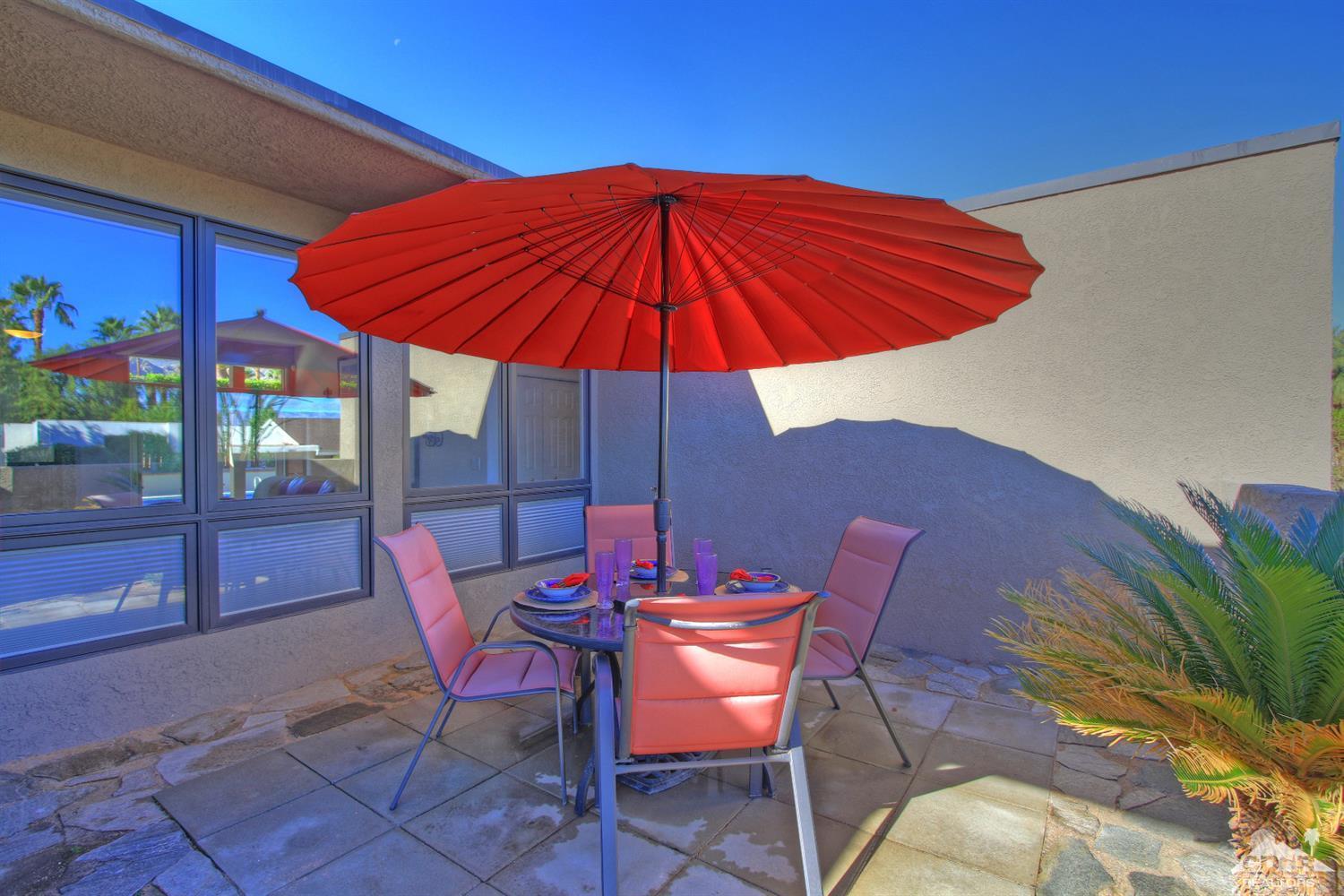 71471 Halgar Road Rancho Mirage, CA 92270 - Photo 18 of 49 a view of an outdoor sitting area with furniture and umbrella