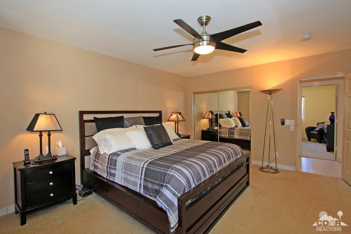 71471 Halgar Road Rancho Mirage, CA 92270 - Photo 27 of 49 a bedroom with a bed and a chandelier