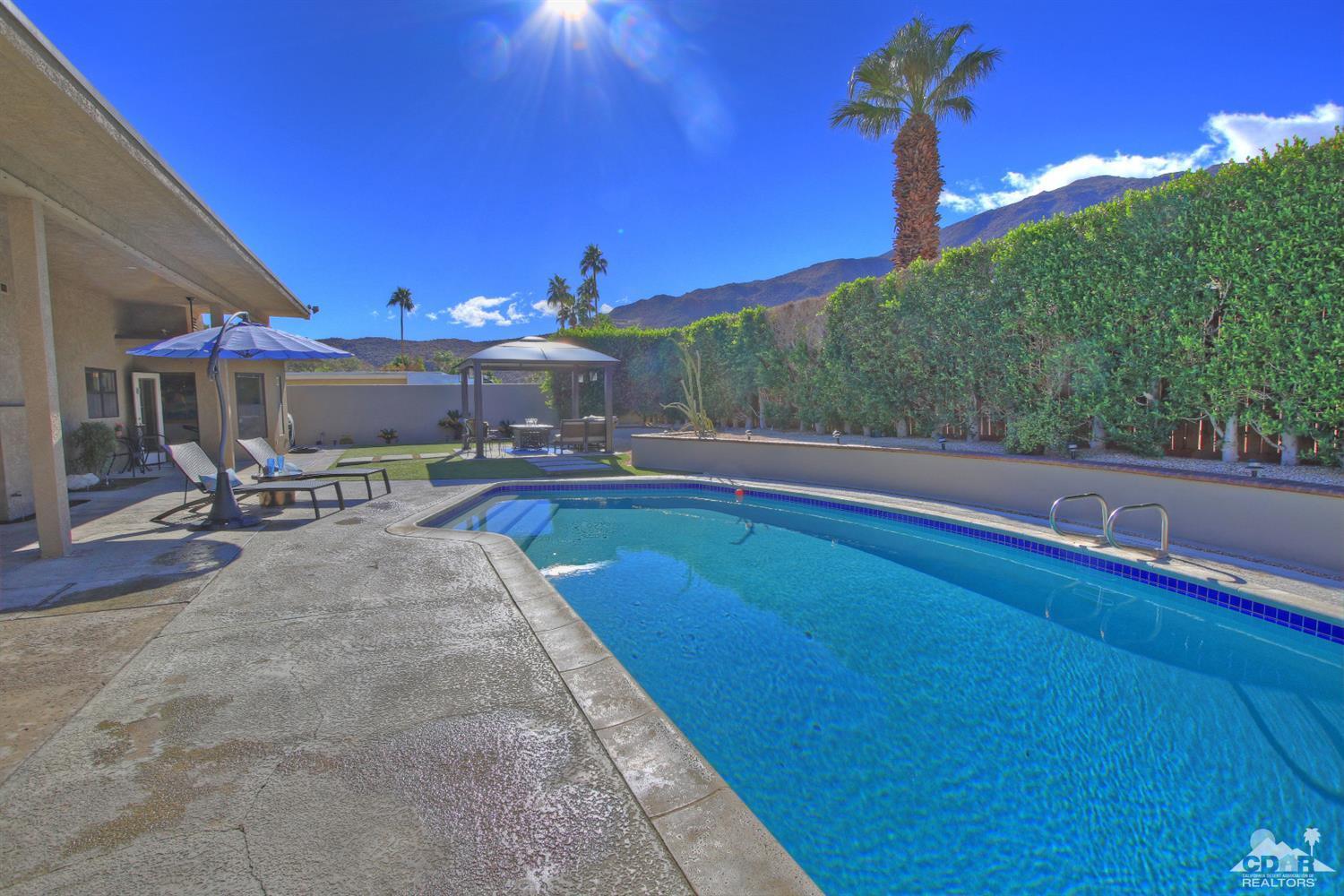 71471 Halgar Road Rancho Mirage, CA 92270 - Photo 38 of 49 a view of a swimming pool with outdoor seating and plants