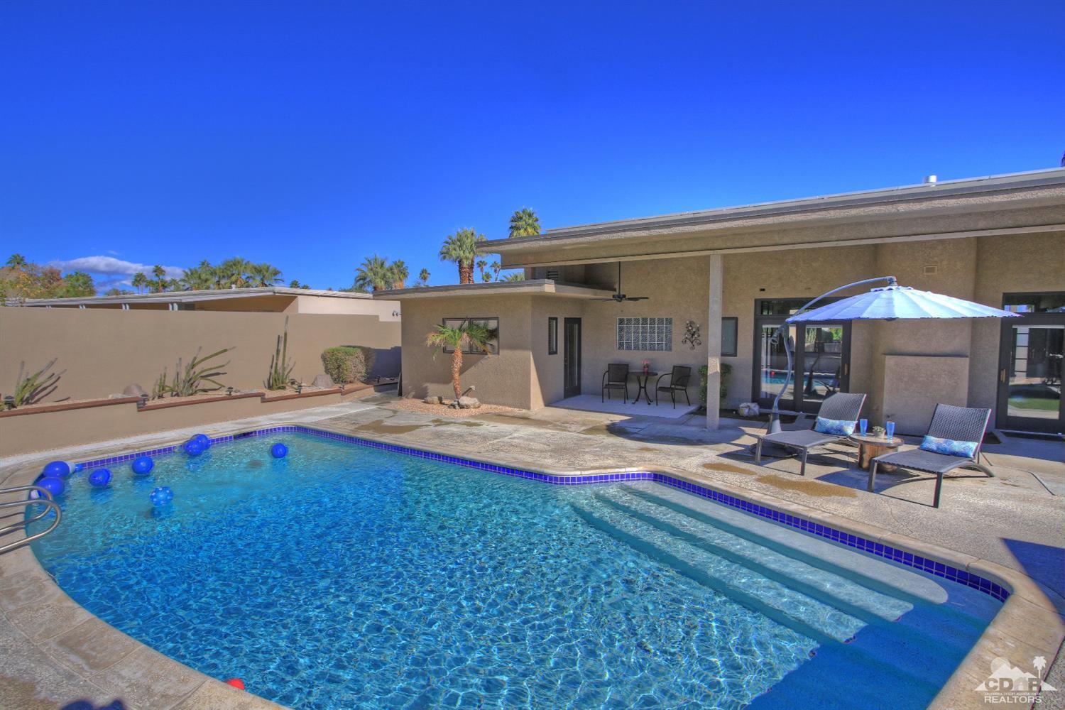 71471 Halgar Road Rancho Mirage, CA 92270 - Photo 41 of 49 a view of swimming pool with outdoor seating and house in the background