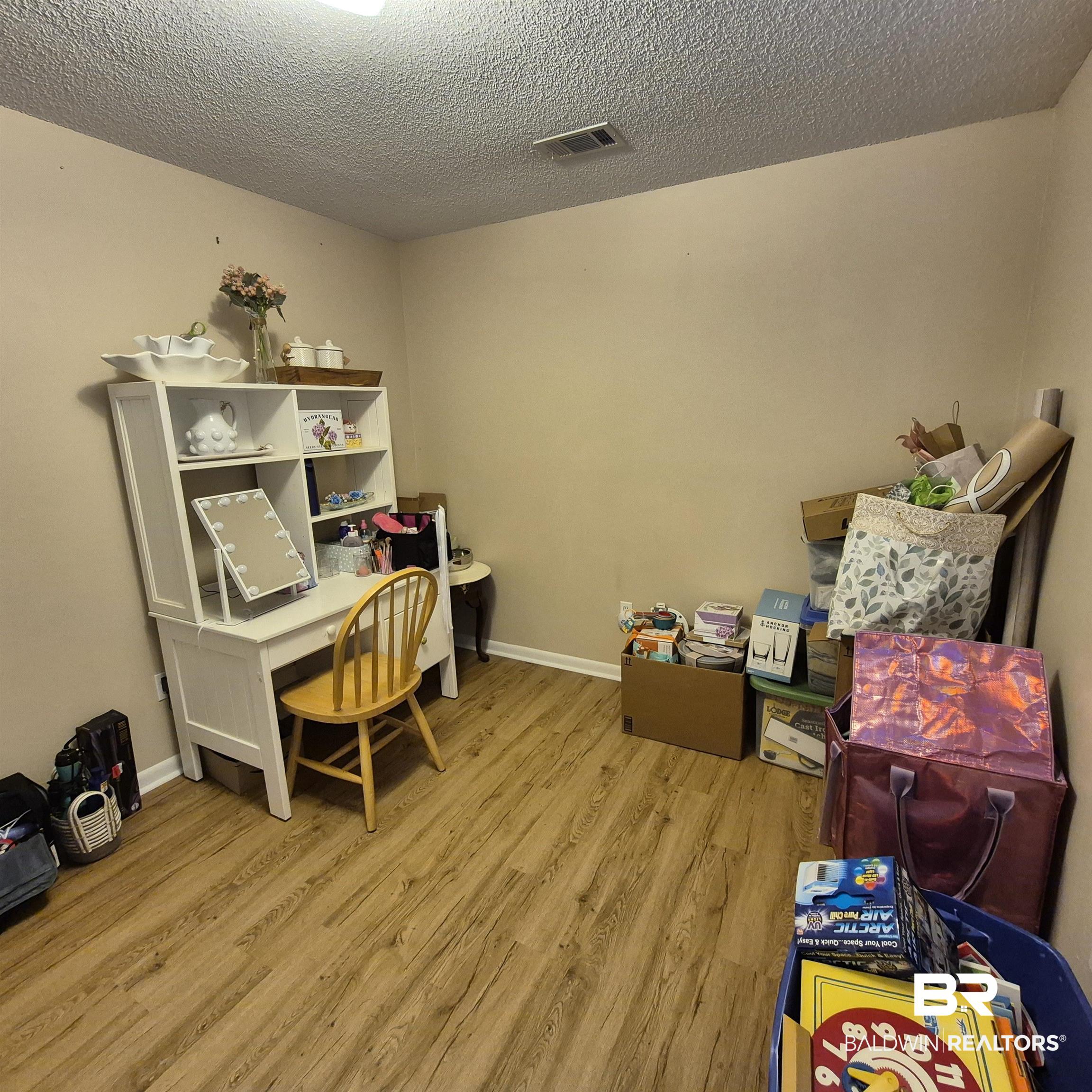 721 Perryman Street Evergreen, AL 36401 - Photo 16 of 26 Office area with light wood-style floors and a textured ceiling