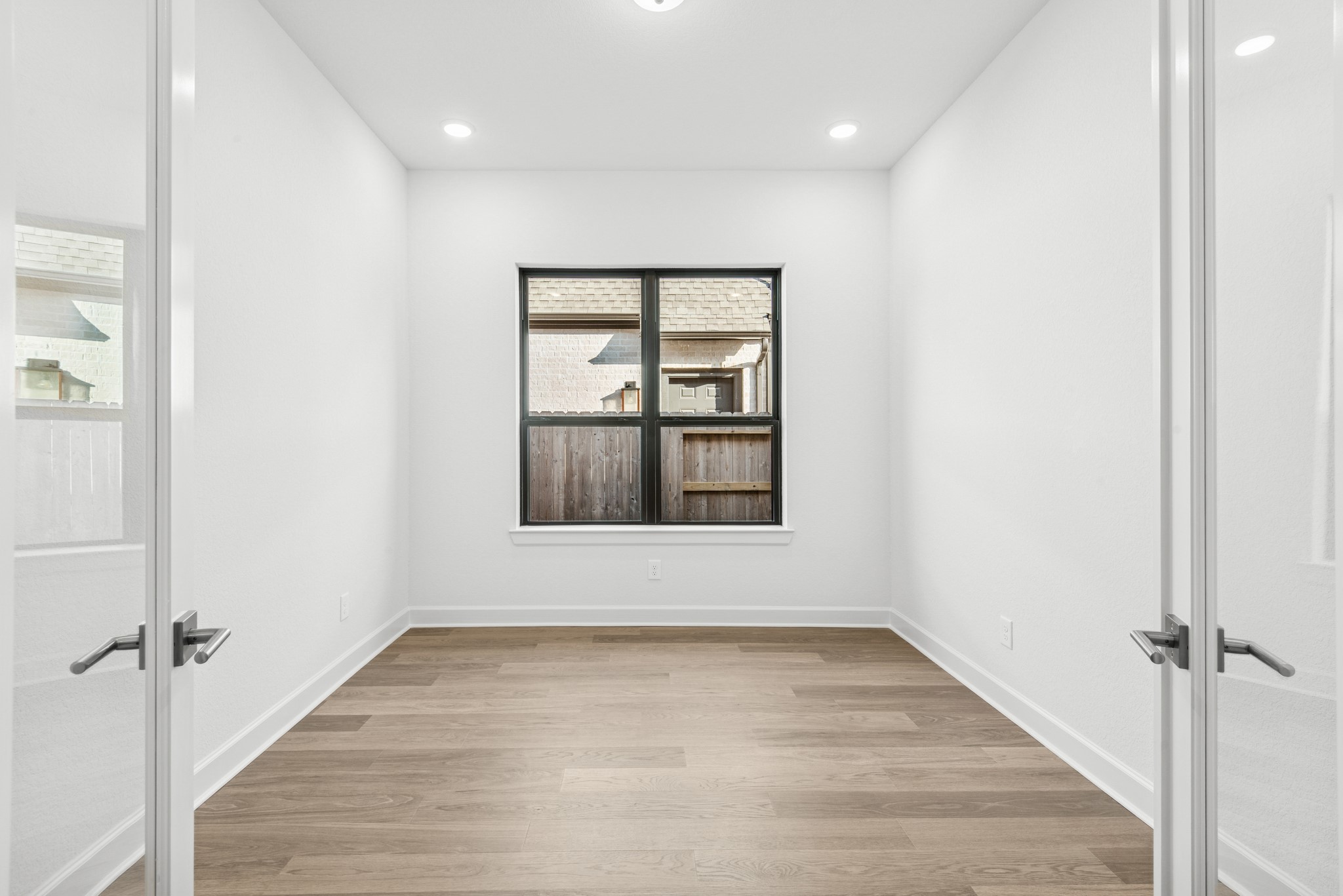 15748 Terracotta Terrace Lane Conroe, TX 77302 - Photo 15 of 50 an empty room with wooden floor and windows