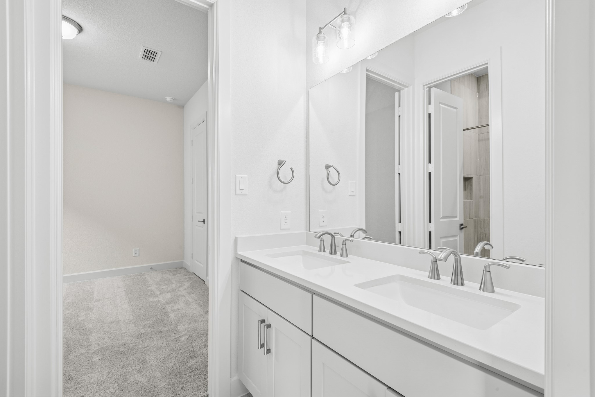 15748 Terracotta Terrace Lane Conroe, TX 77302 - Photo 20 of 50 a bathroom with double vanity sink and a mirror
