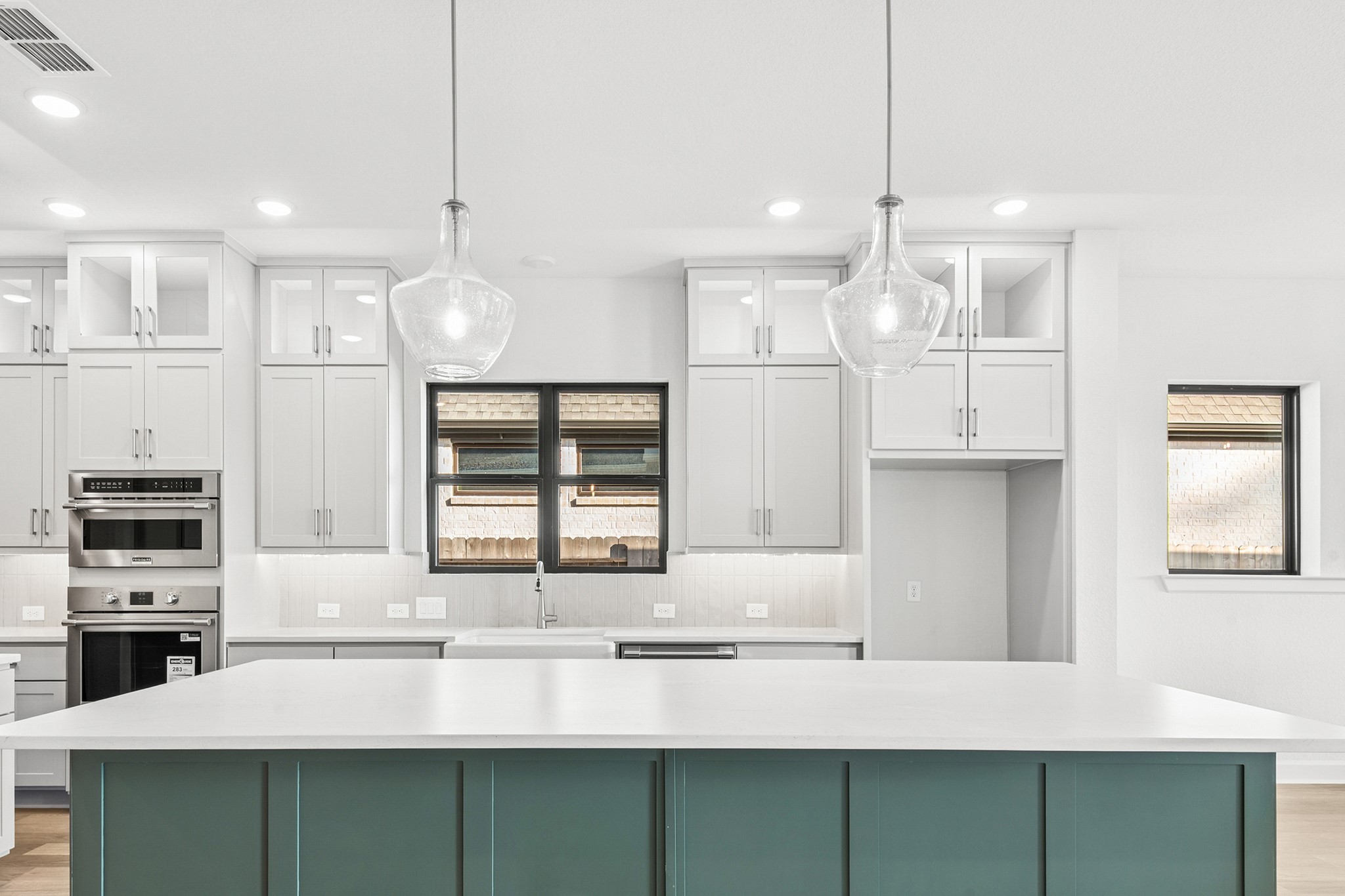 15748 Terracotta Terrace Lane Conroe, TX 77302 - Photo 27 of 50 a kitchen with stainless steel appliances kitchen island granite countertop a sink and microwave
