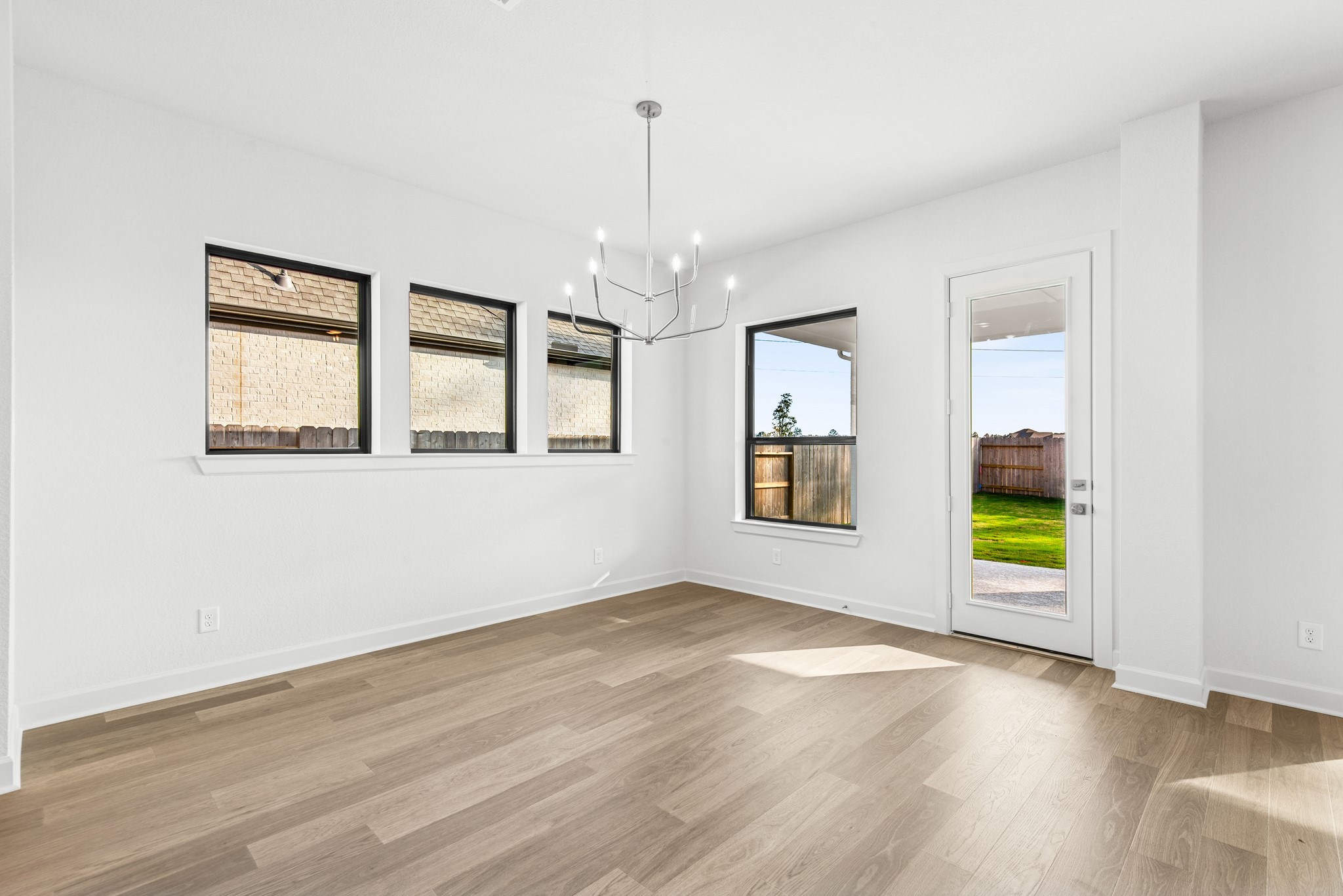 15748 Terracotta Terrace Lane Conroe, TX 77302 - Photo 30 of 50 wooden floor in an empty room with a window