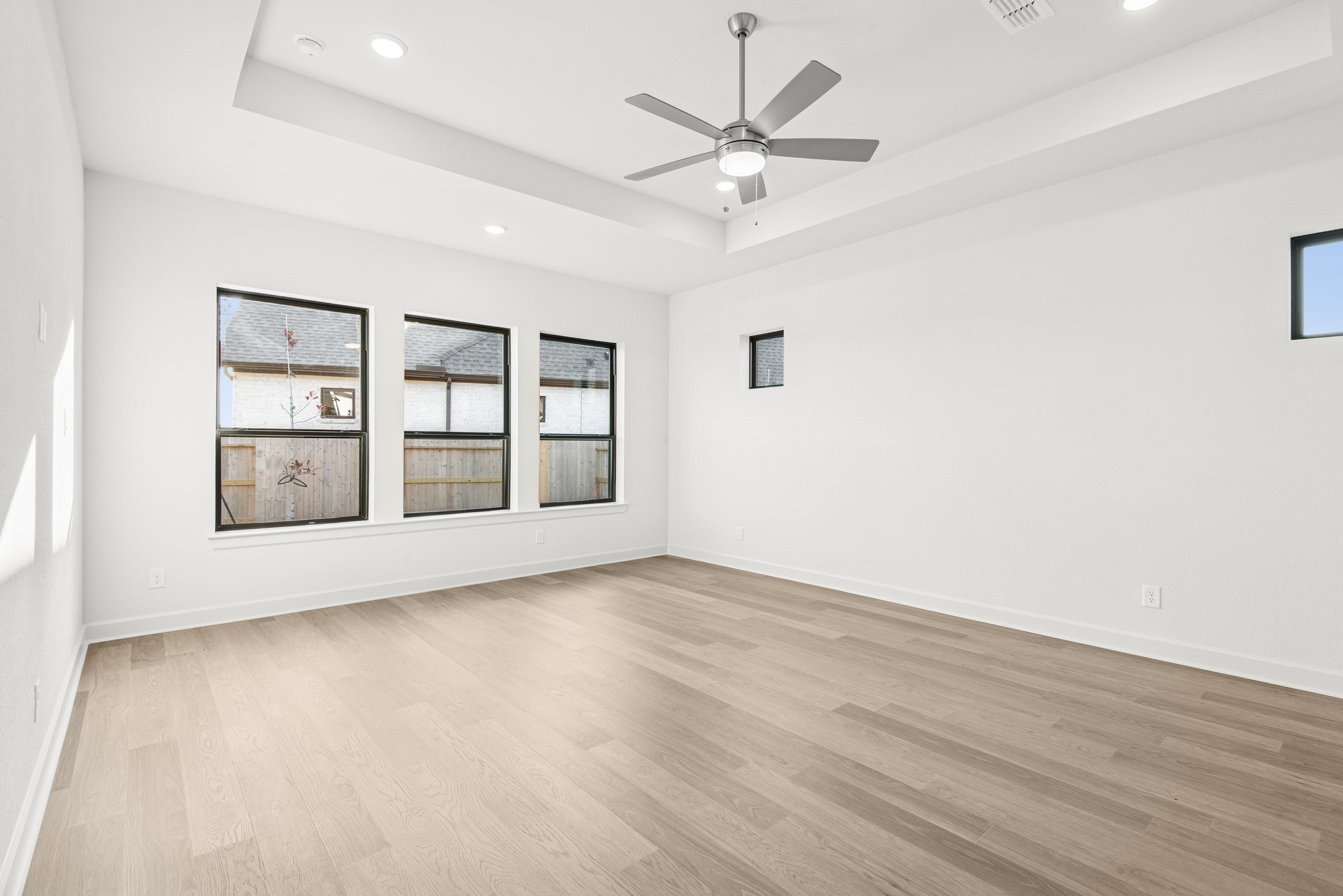 15748 Terracotta Terrace Lane Conroe, TX 77302 - Photo 36 of 50 an empty room with wooden floor fan and windows