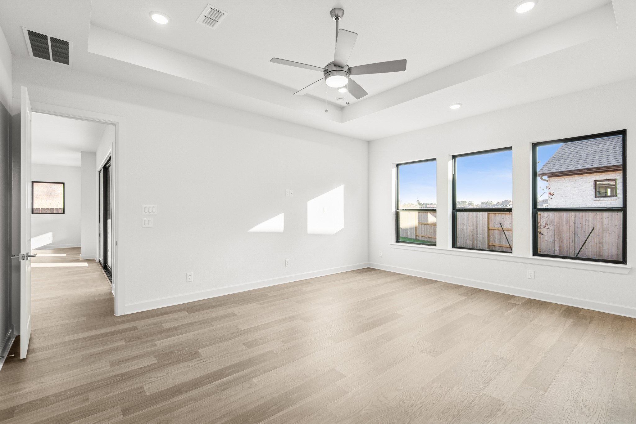 15748 Terracotta Terrace Lane Conroe, TX 77302 - Photo 38 of 50 a view of an empty room with window and wooden floor